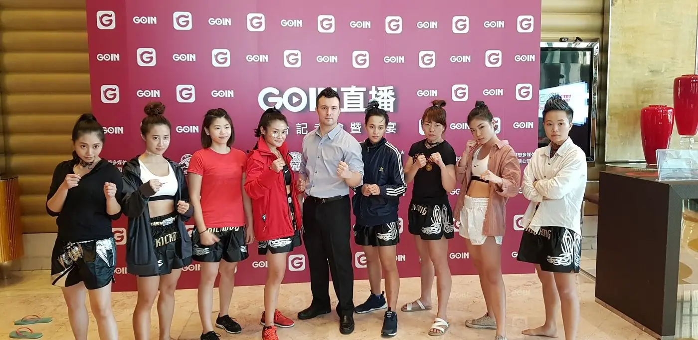 Daniel Flash standing with a team of fighters at an event in Asia