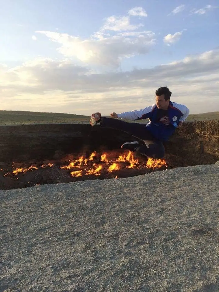 Daniel Flash performing a flying side kick over a burning fire