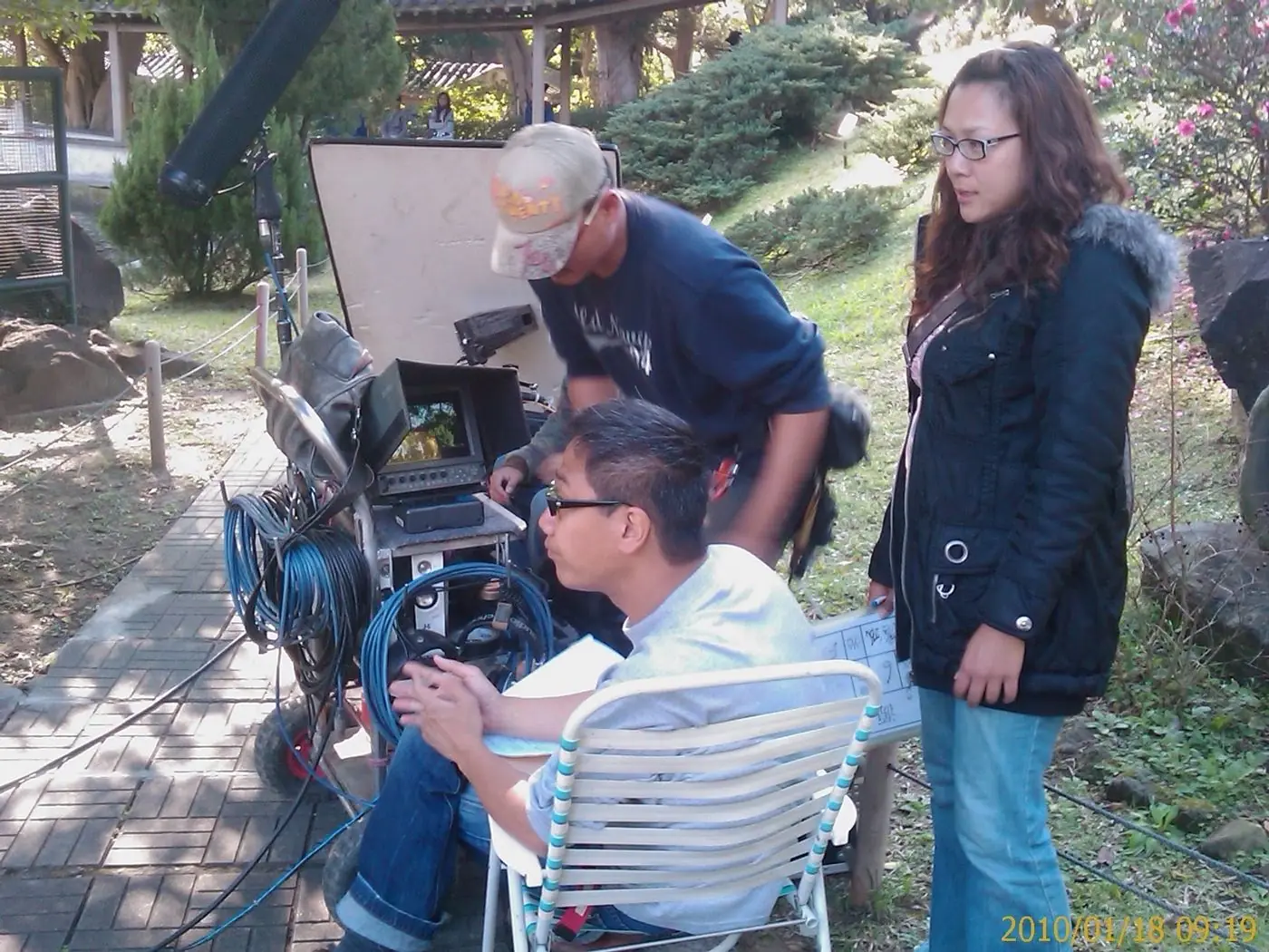 Film crew and camera on a martial arts film set in Asia