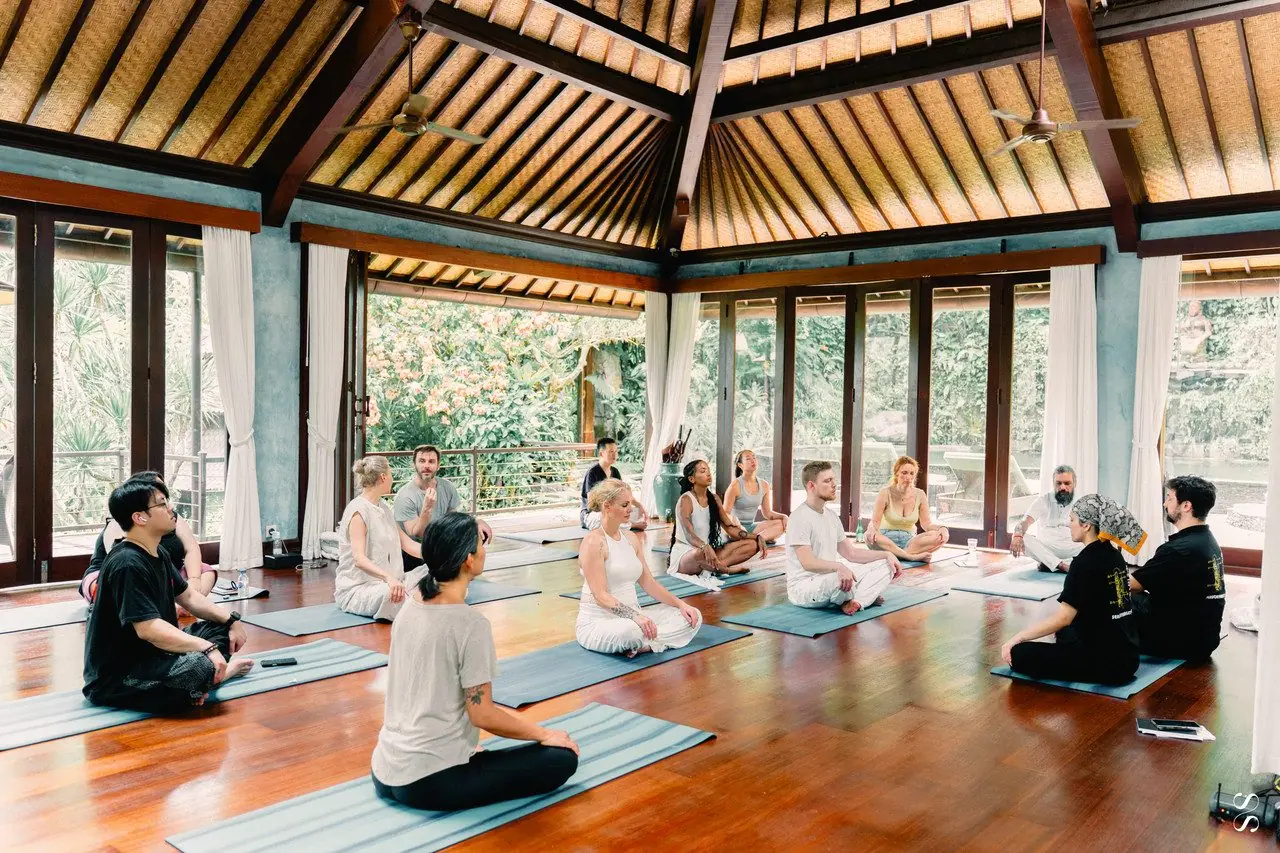Dr. Daniel Flash teaching a group in a wooden pavilion
