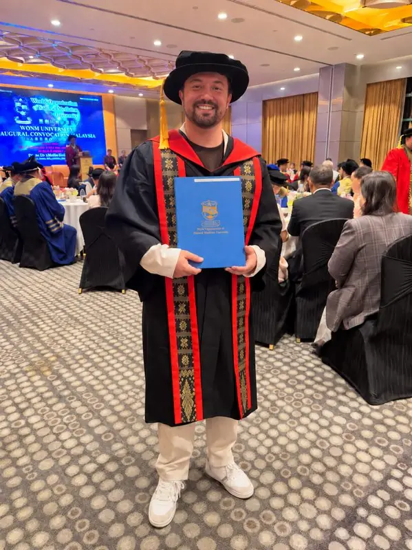 Dr. Daniel Flash at the WONM graduation dinner in doctoral gown