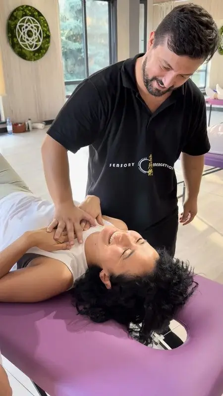 Dr. Daniel Flash working on the neck of a client lying on a treatment table