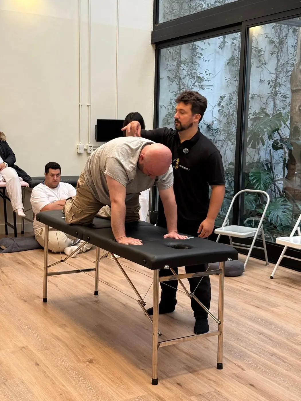 Dr. Daniel Flash working with a client on a treatment table