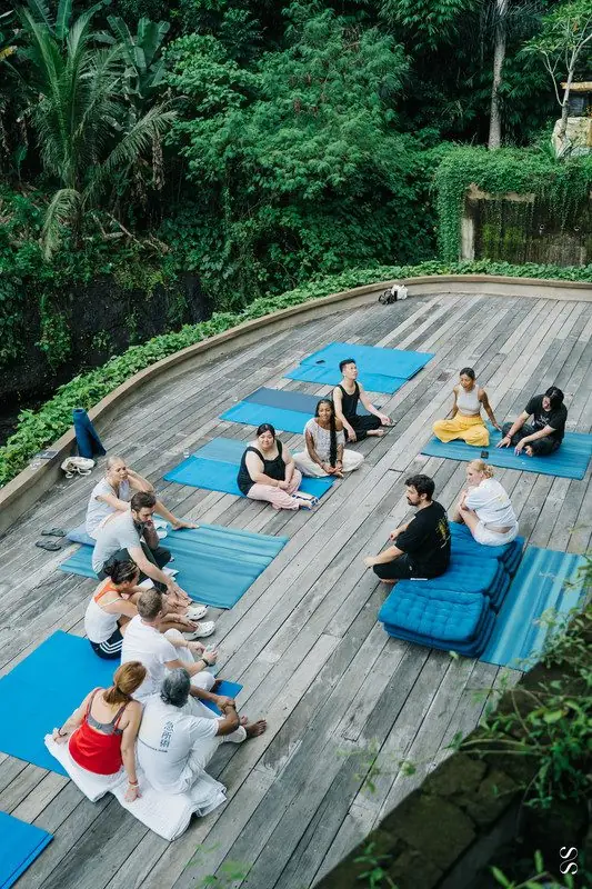 Students practising Sensory Energetics outdoors on blue mats