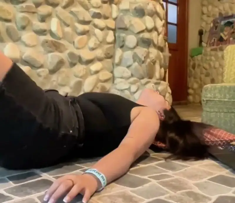 A member following a lesson on her laptop at home