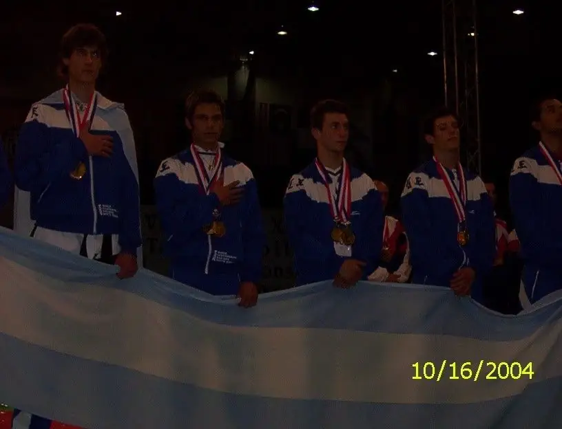 Argentine national team with medals standing behind the Argentine flag