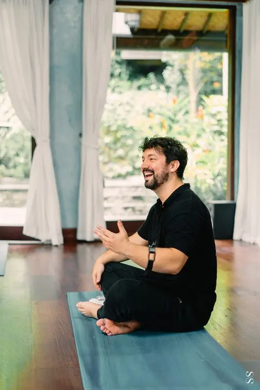 Dr. Daniel Flash seated, smiling during a session
