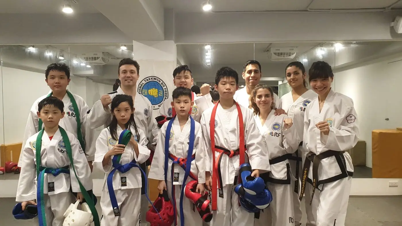 Daniel Flash with a group of young Taekwon-Do students holding medals