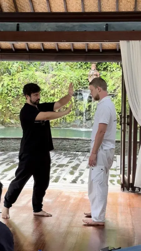 Dr. Daniel Flash guiding a client standing in an open-air room